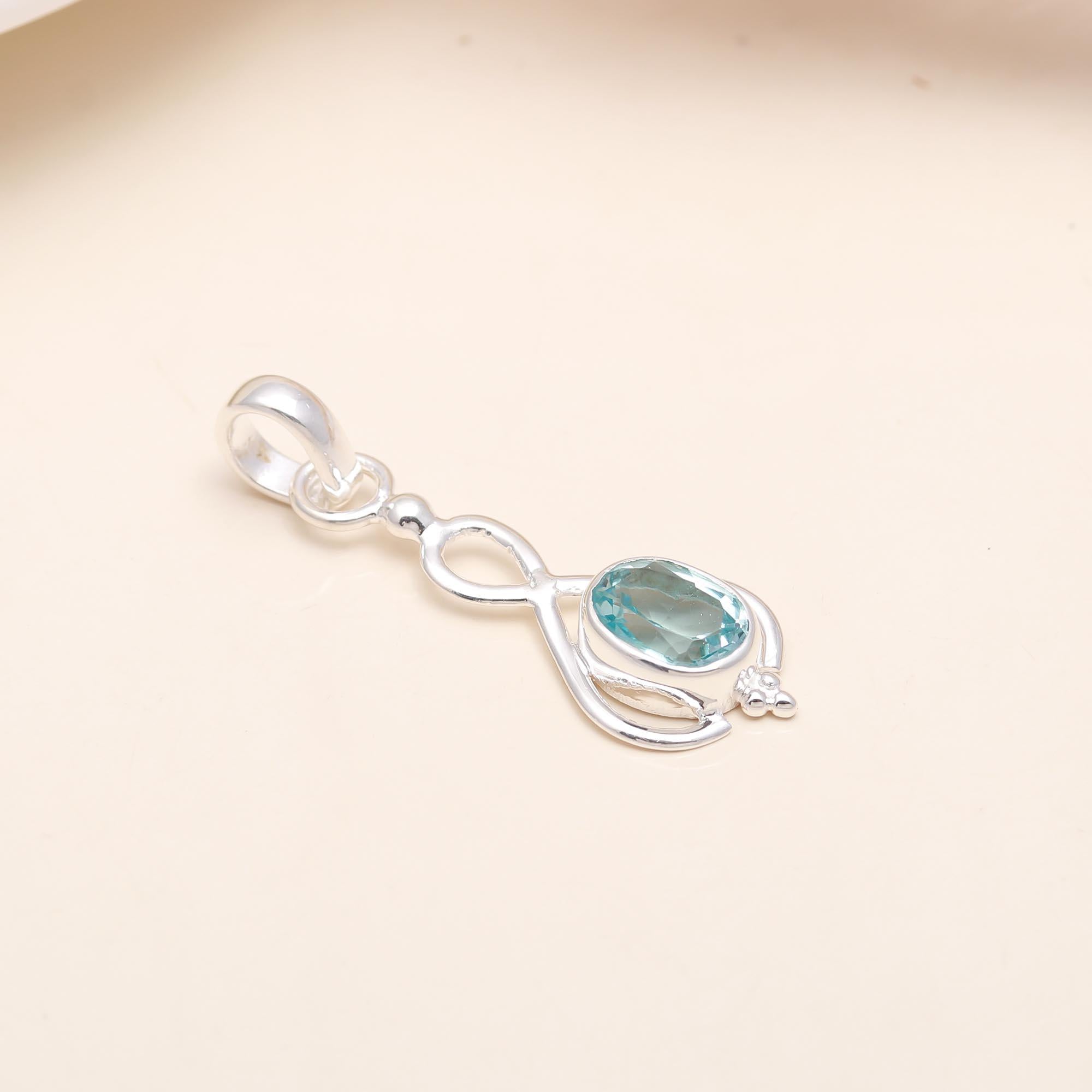 The Azure Drop: Blue Topaz Oval Cabochon Pendant
