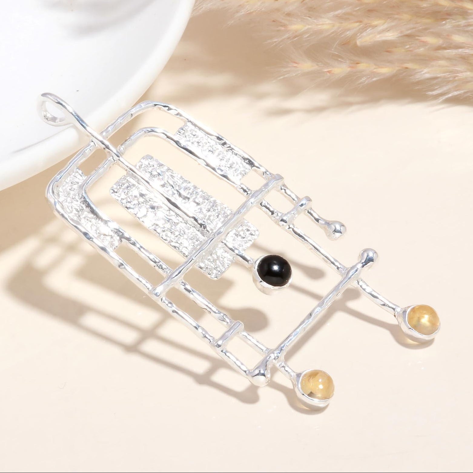Decorative metal rack with black and gold balls on a neutral background