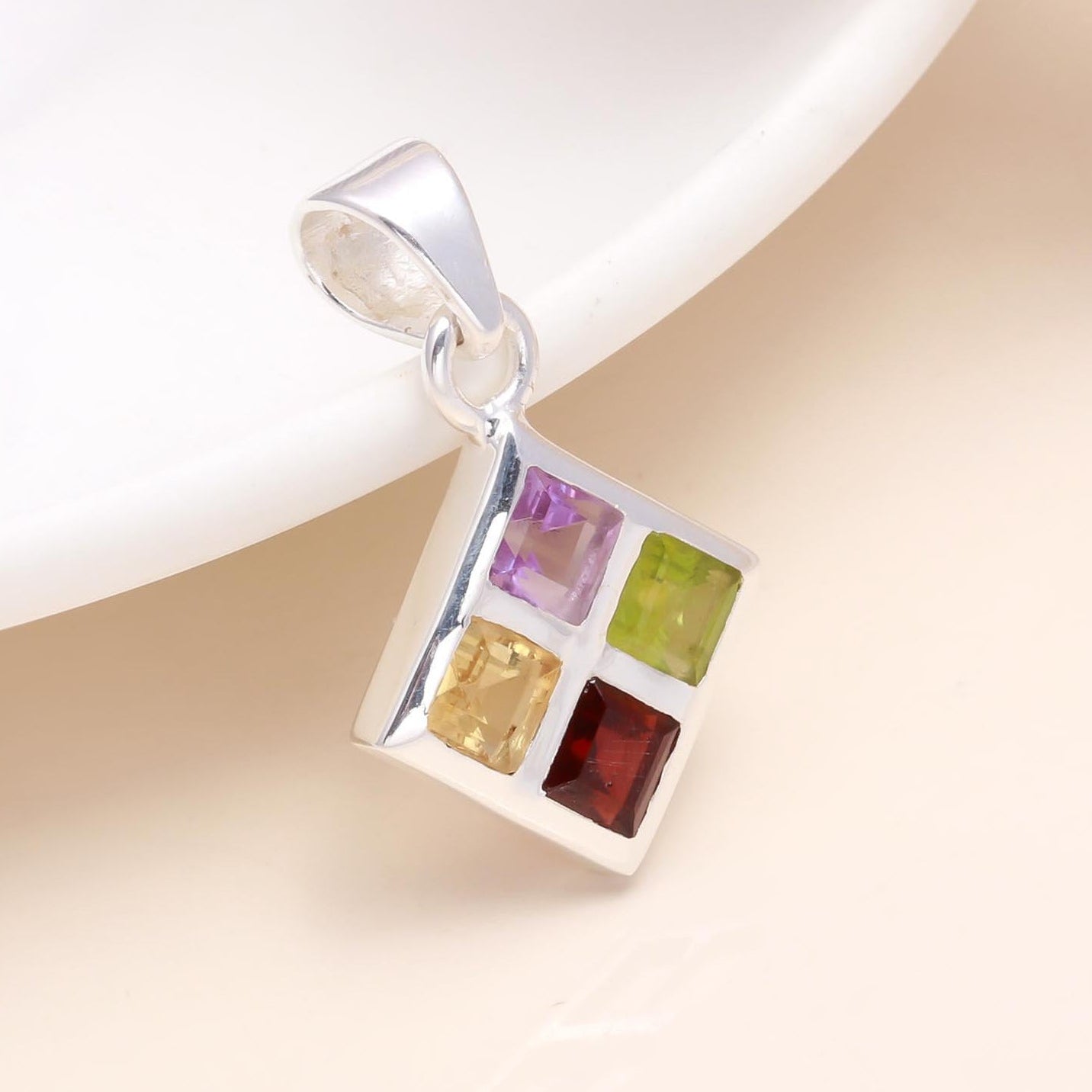 A 925 sterling silver square pendant featuring a variety of natural gemstones arranged in a unique pattern, displayed against a light background.