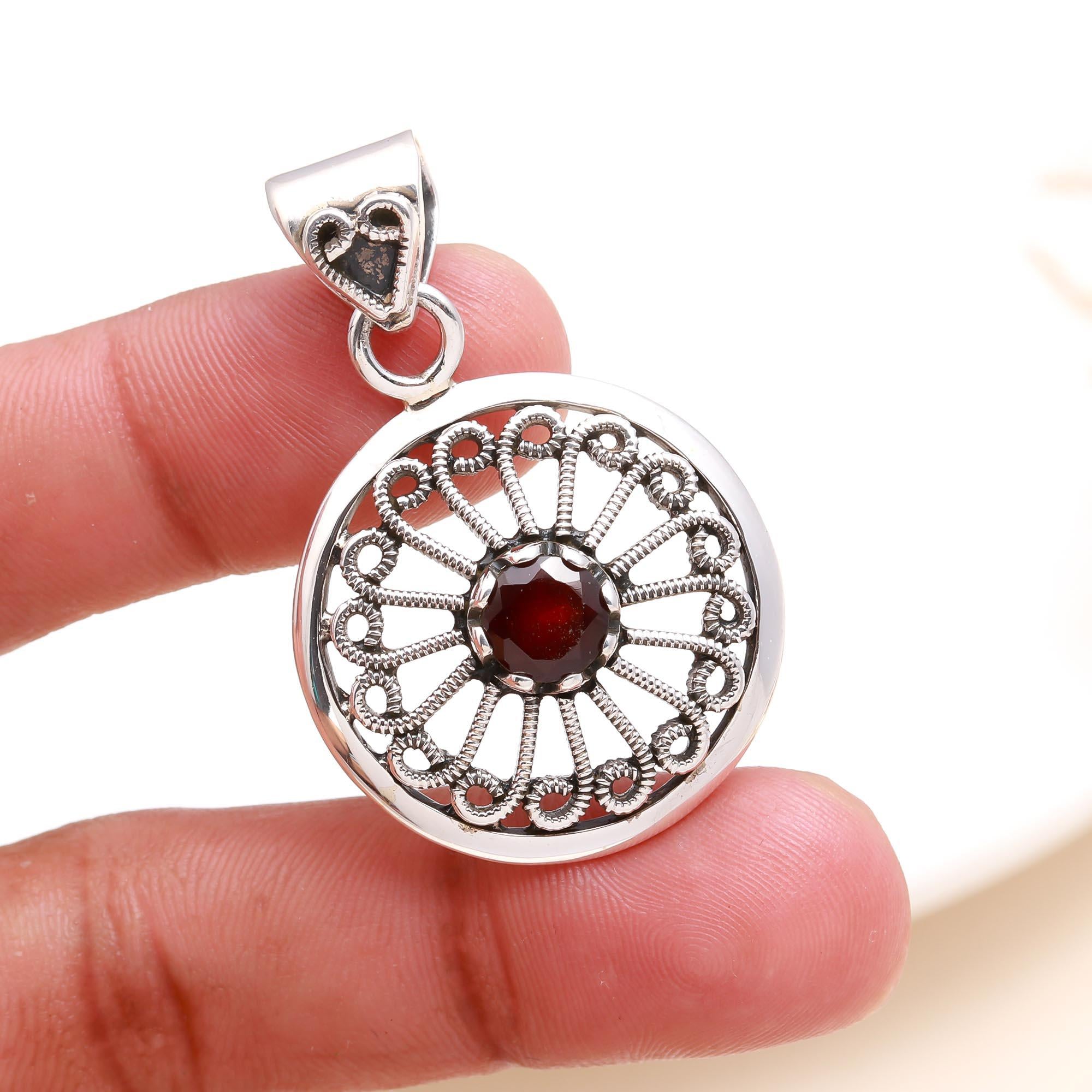 The Garnet Sunwheel: Ornate Silver Circular Pendant