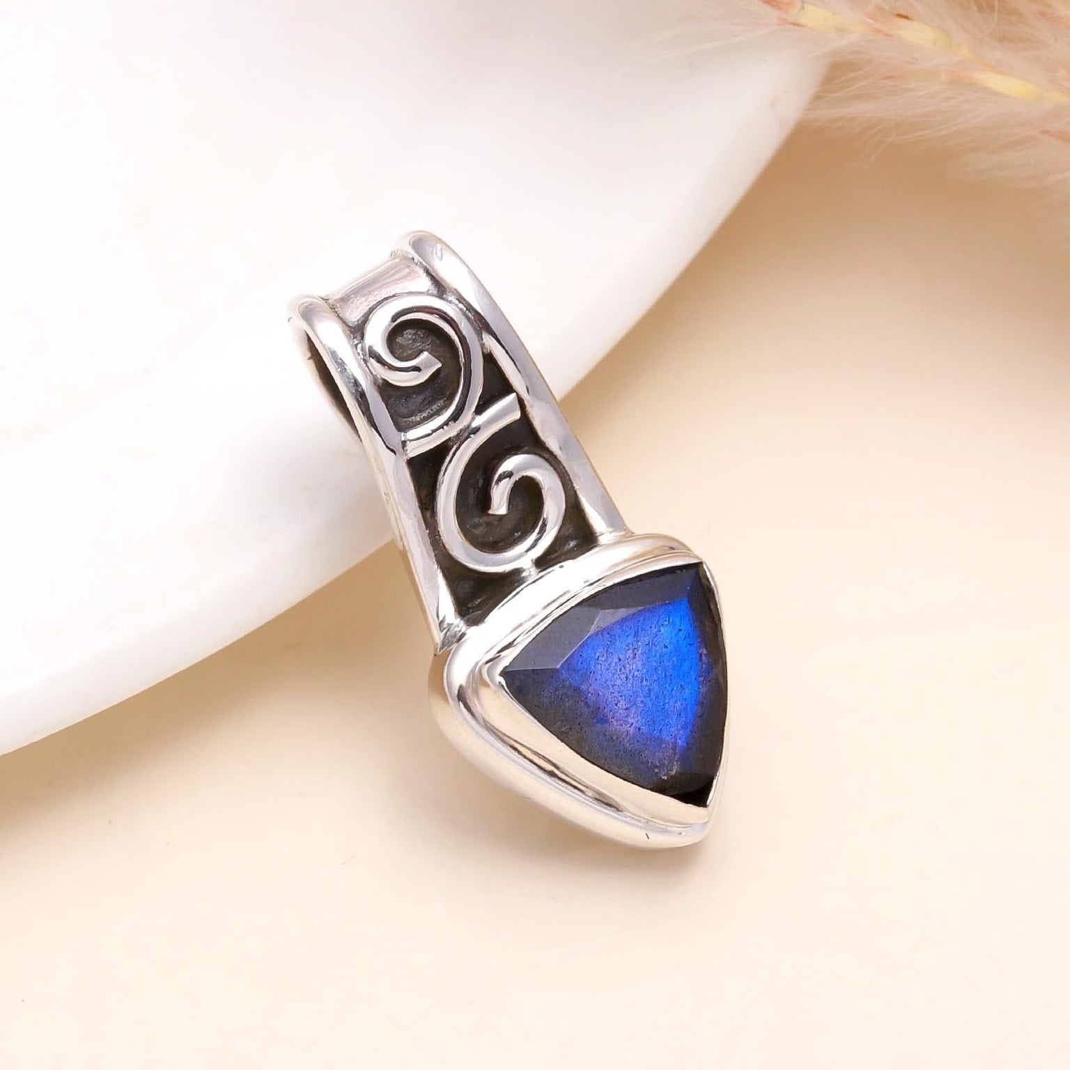 A 925 Sterling Silver pendant with a Mystic Blue Labradorite gemstone, displayed against a neutral background.