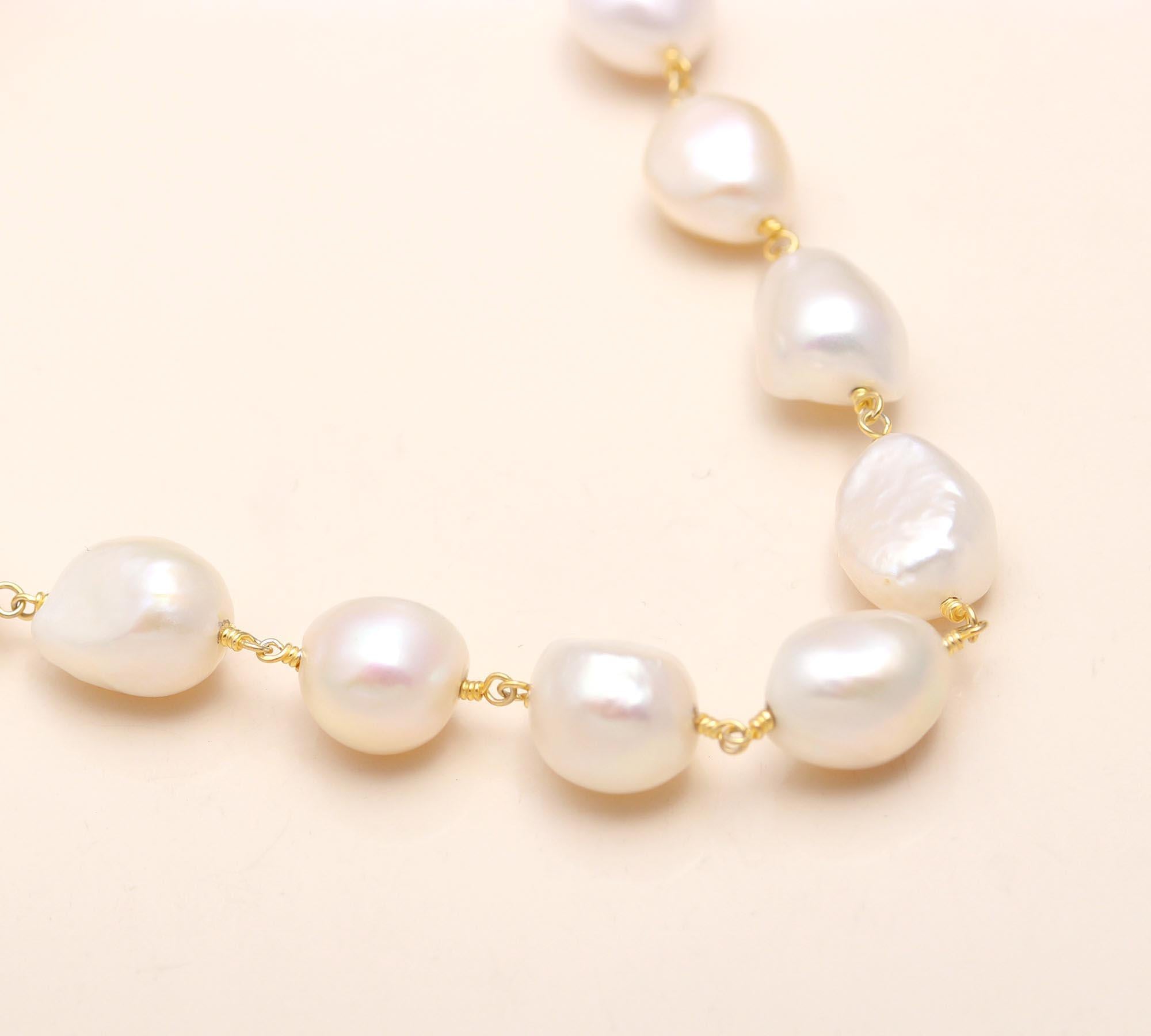 Pearl necklace on a light pink background