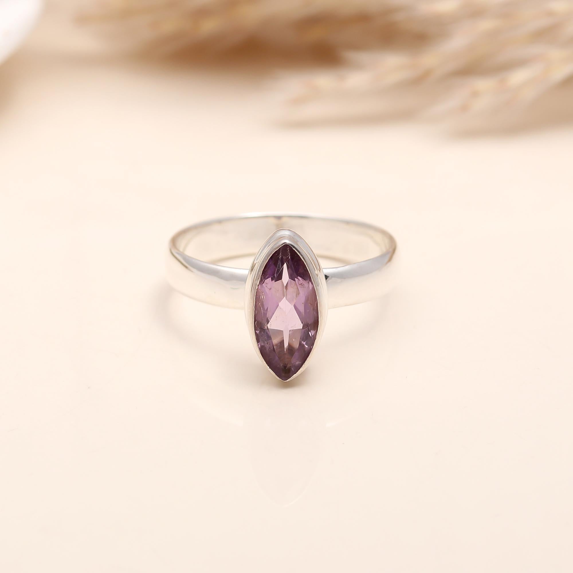 Elegant solitaire ring featuring elongated amethyst gemstone