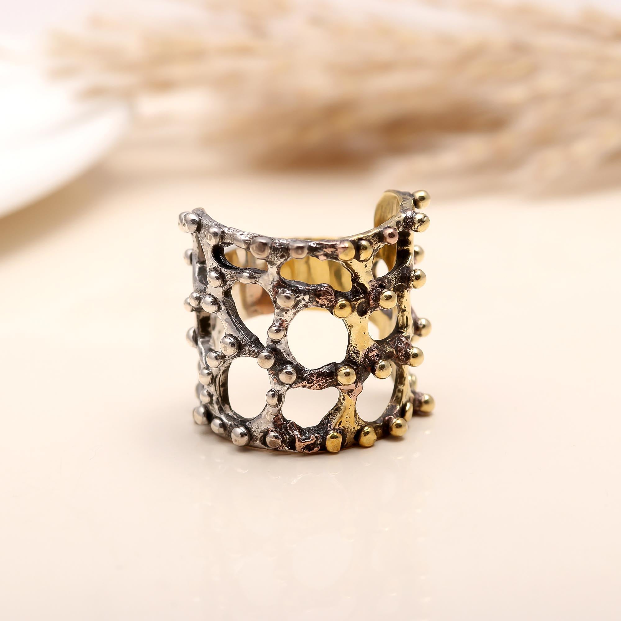 Modern openwork cutout ring in sterling silver and gold