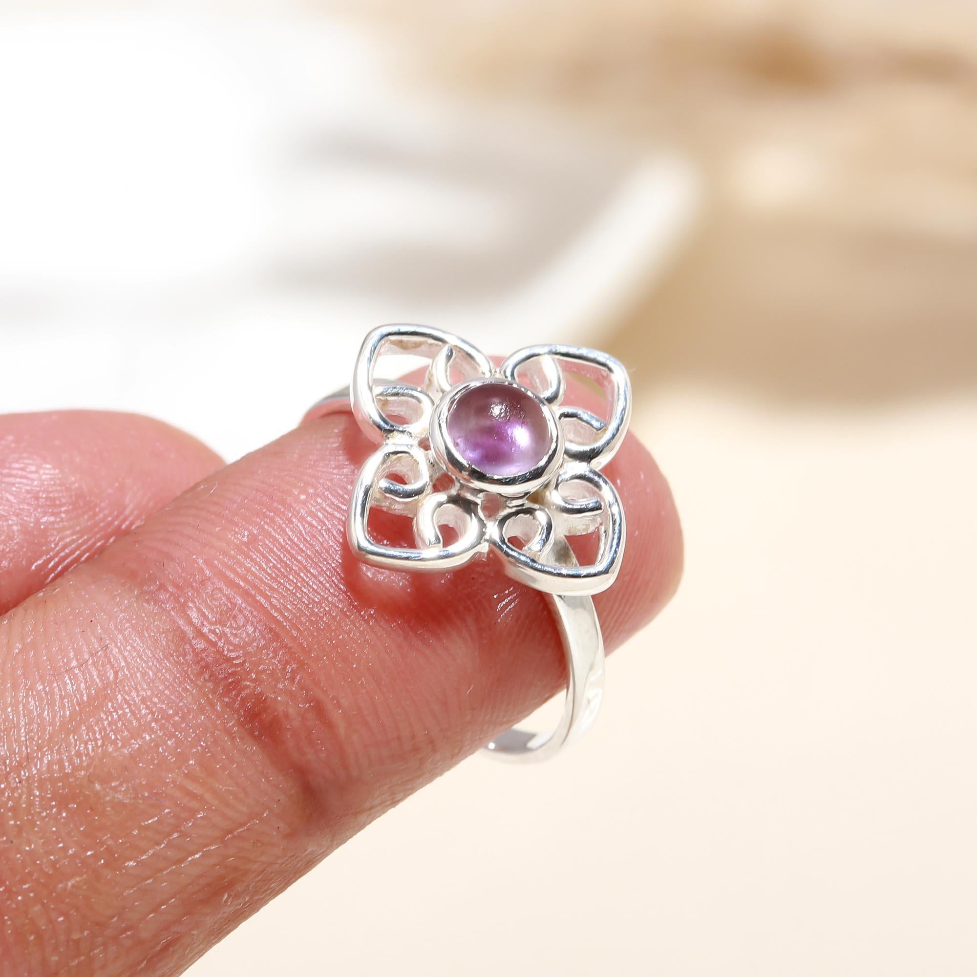 Elegant purple amethyst ring with floral design on finger