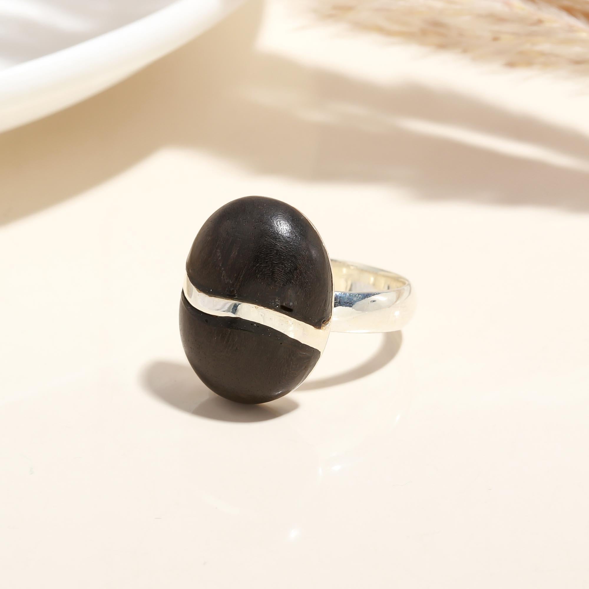 Close-up of oval ebony wood silver statement ring