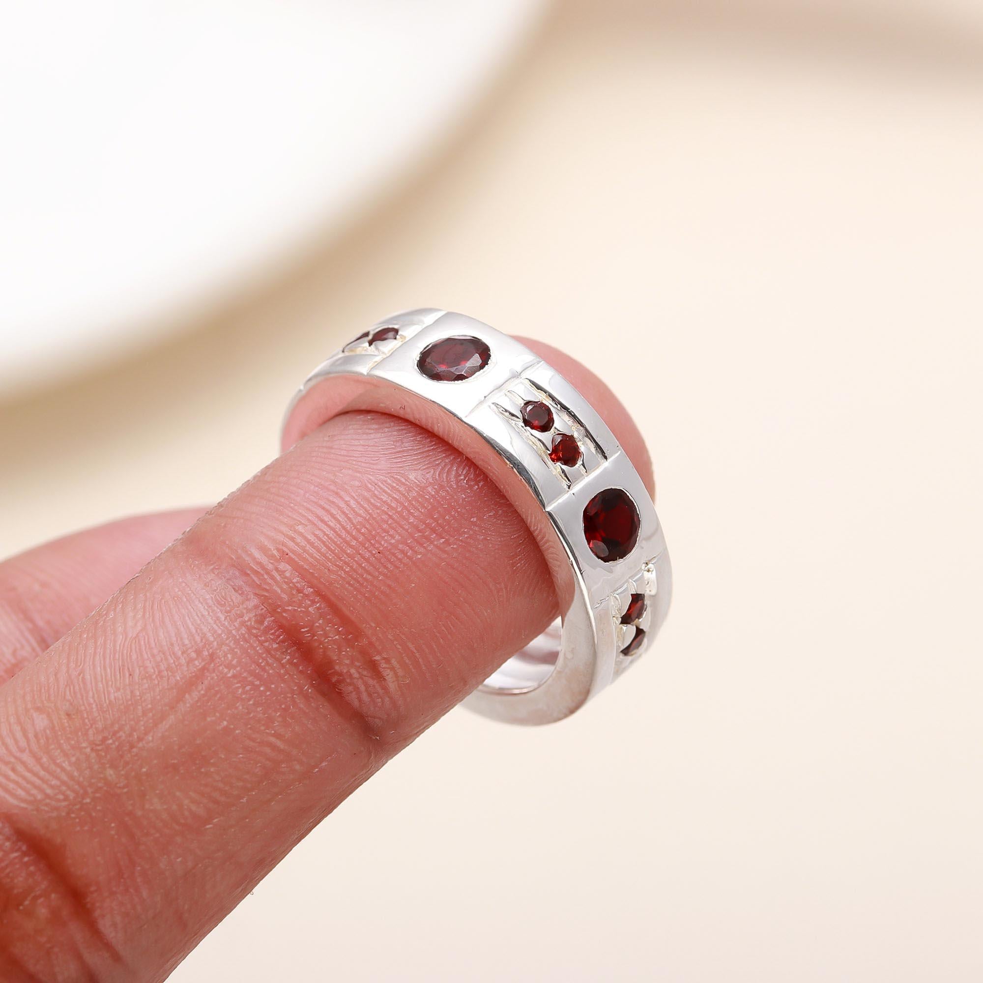 Elegant garnet studded ring on finger