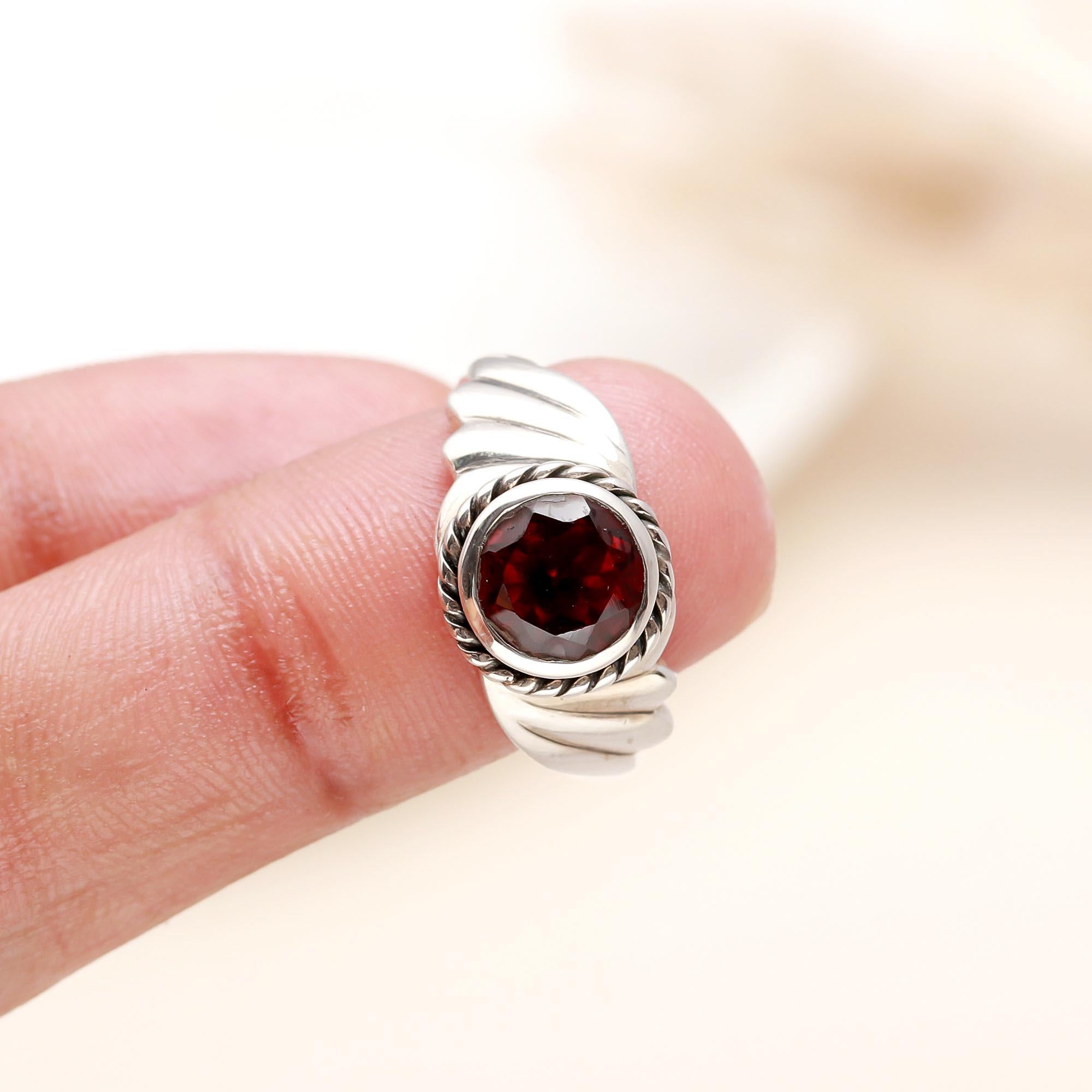 Elegant garnet rope design ring on finger