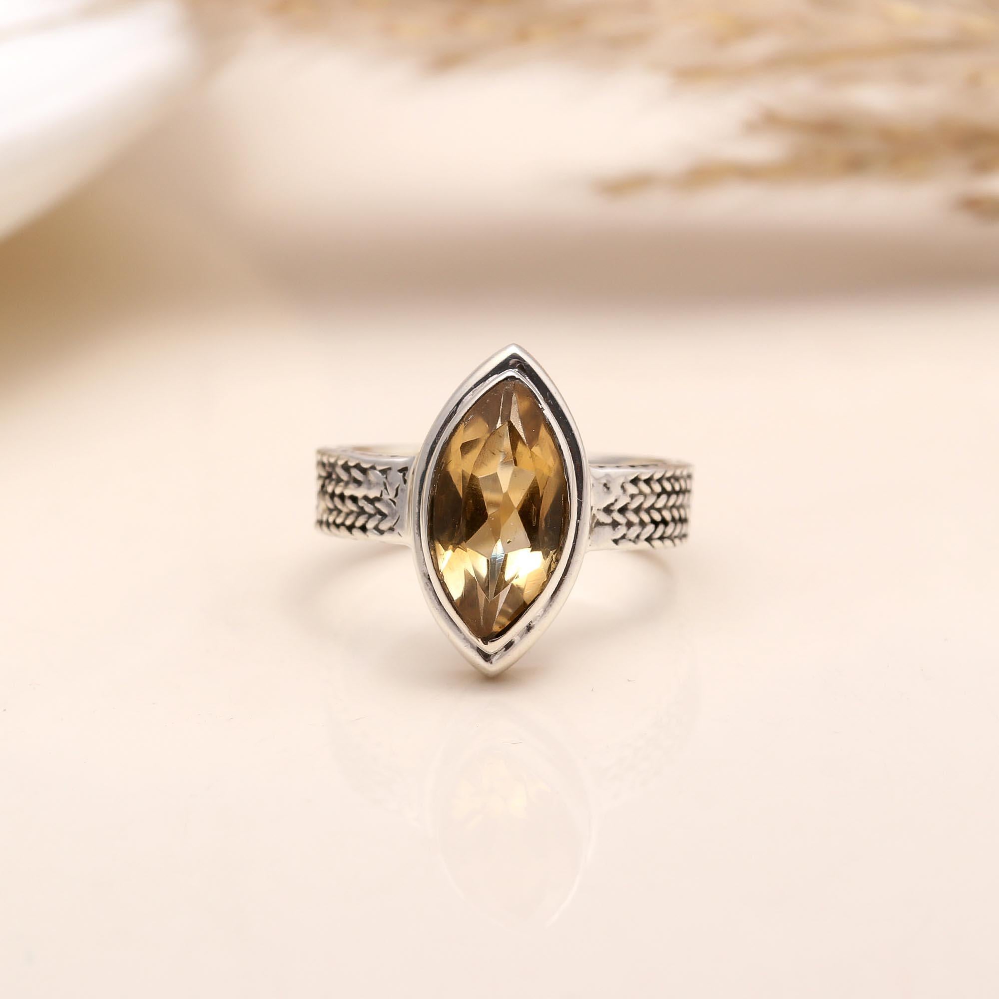 Close-up of marquise cut citrine woven silver ring