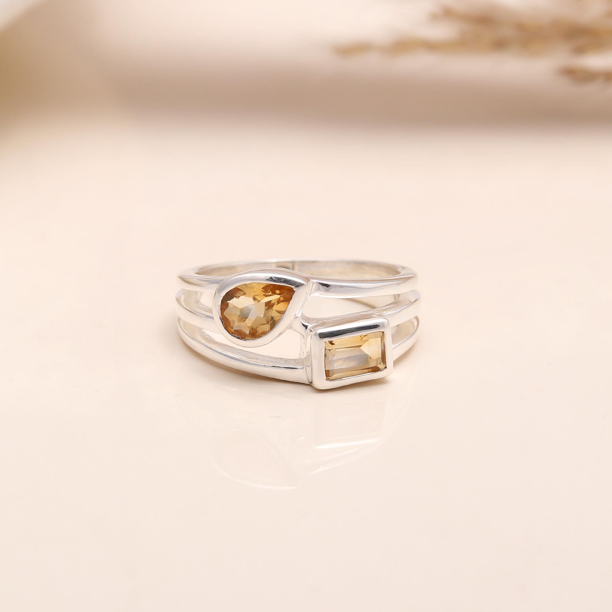Close-up of dual citrine gemstone open silver band ring