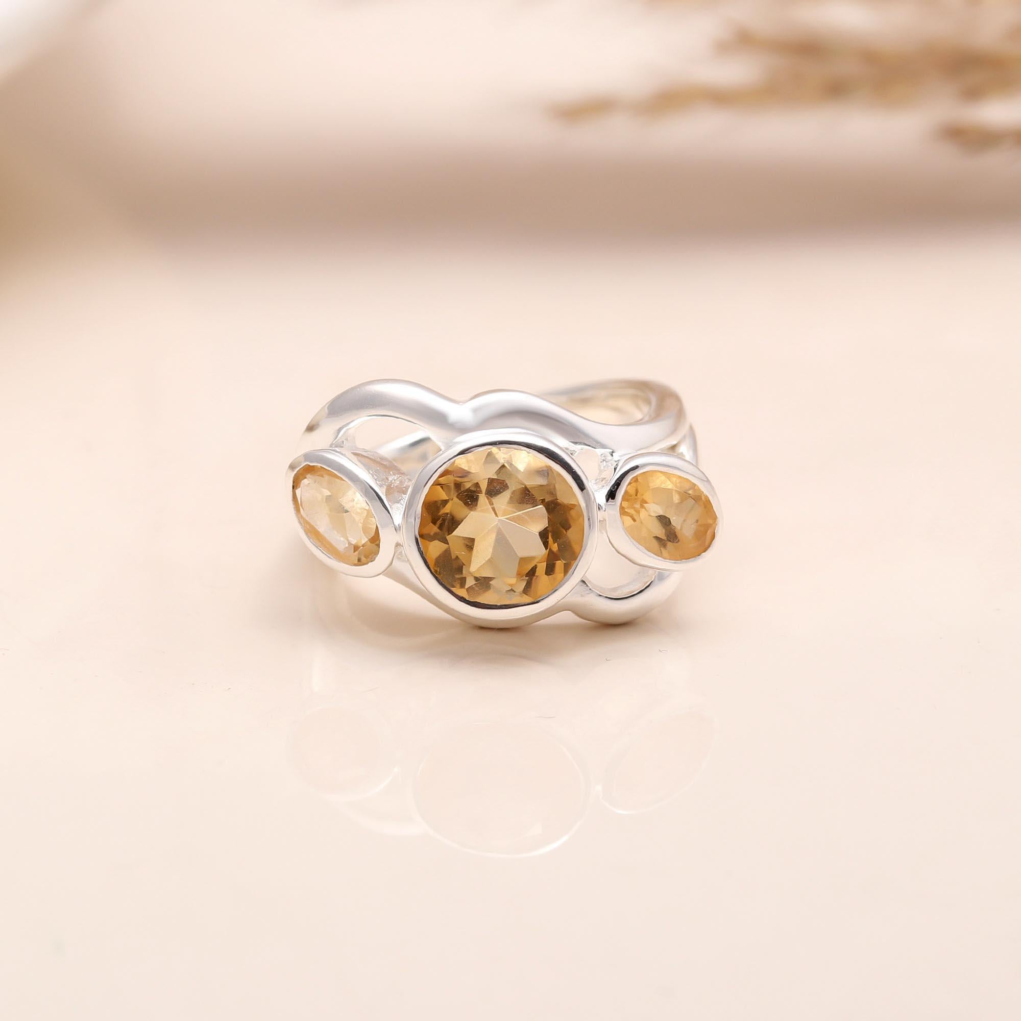 Close-up of three citrine gemstone designer silver ring