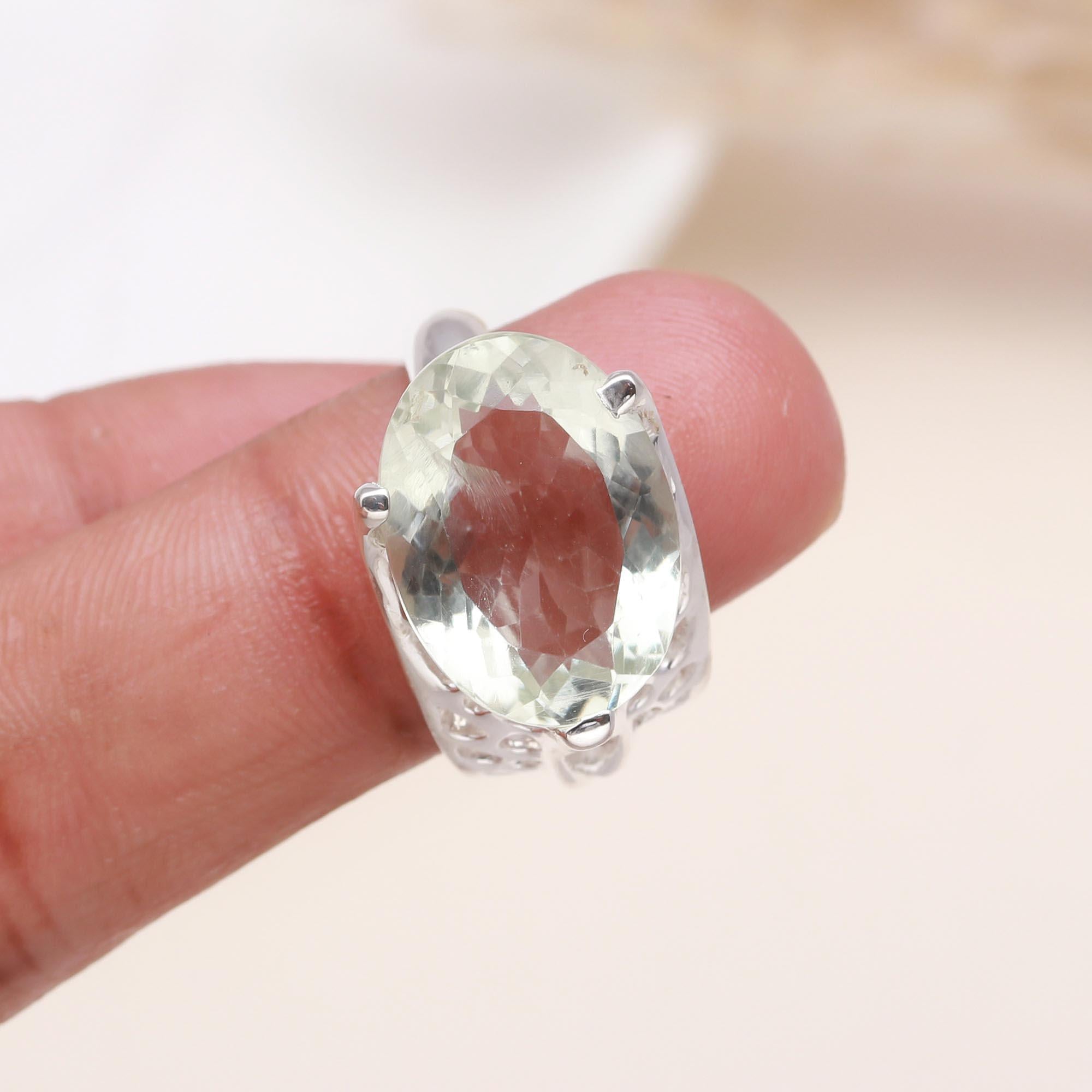 Elegant oval green amethyst ring on finger