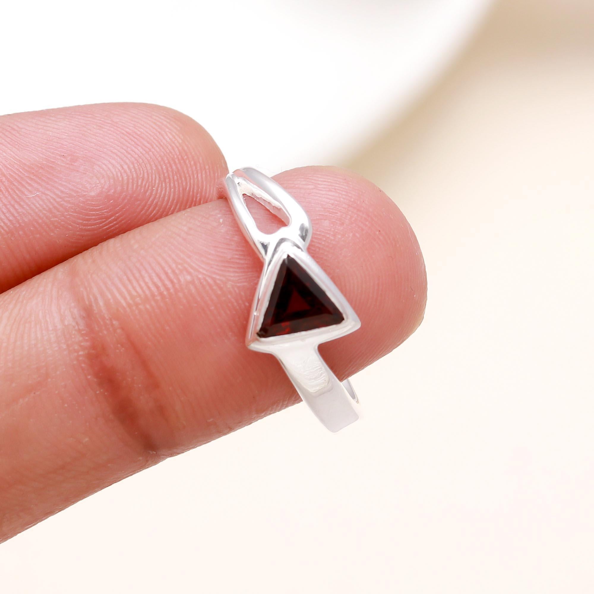 Elegant trillion cut garnet gemstone ring on finger