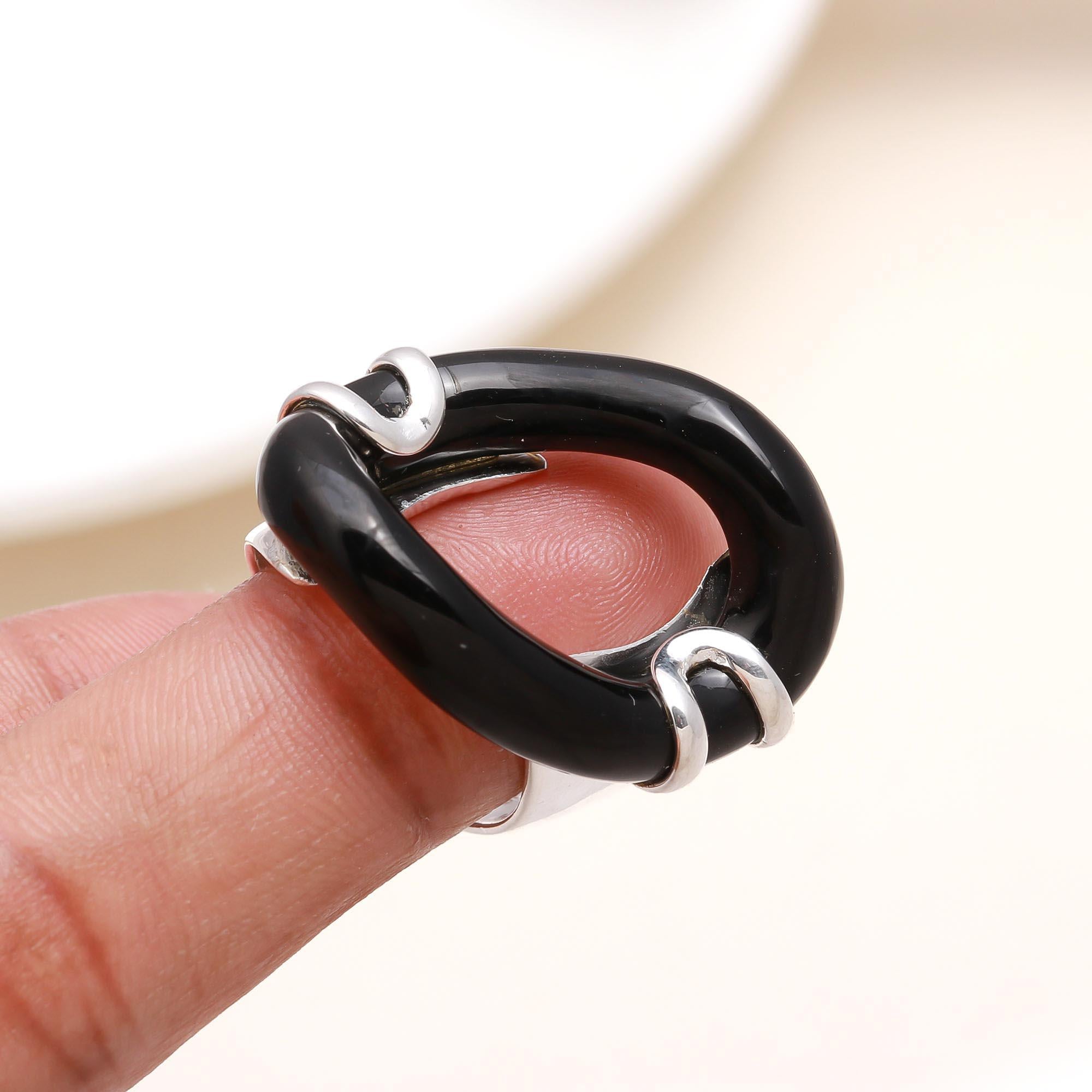 Elegant black enamel statement ring on finger