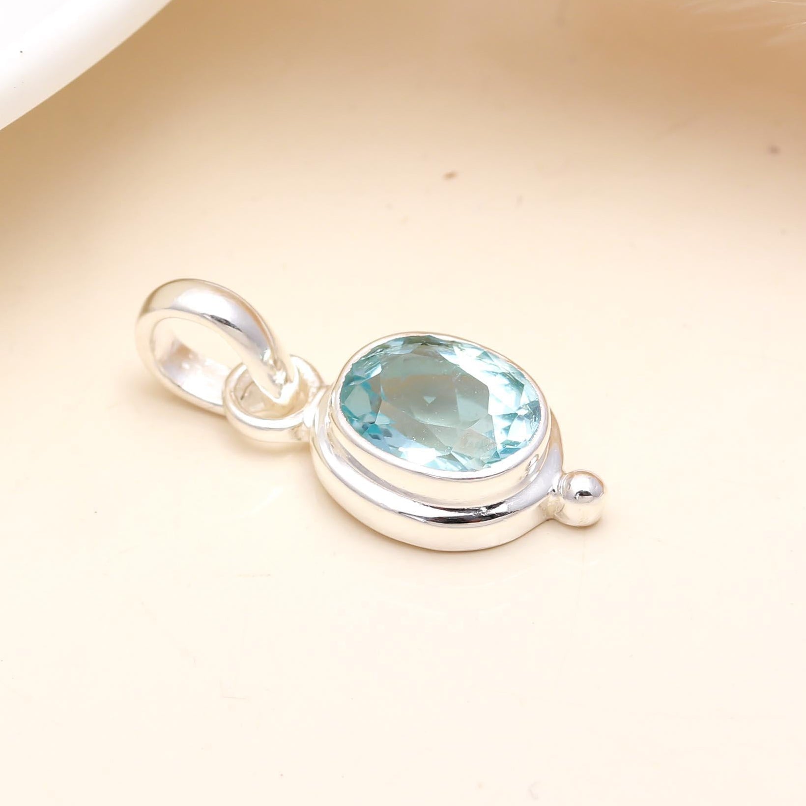 The Sky Drop: Oval Blue Topaz Dainty Bezel Silver Pendant