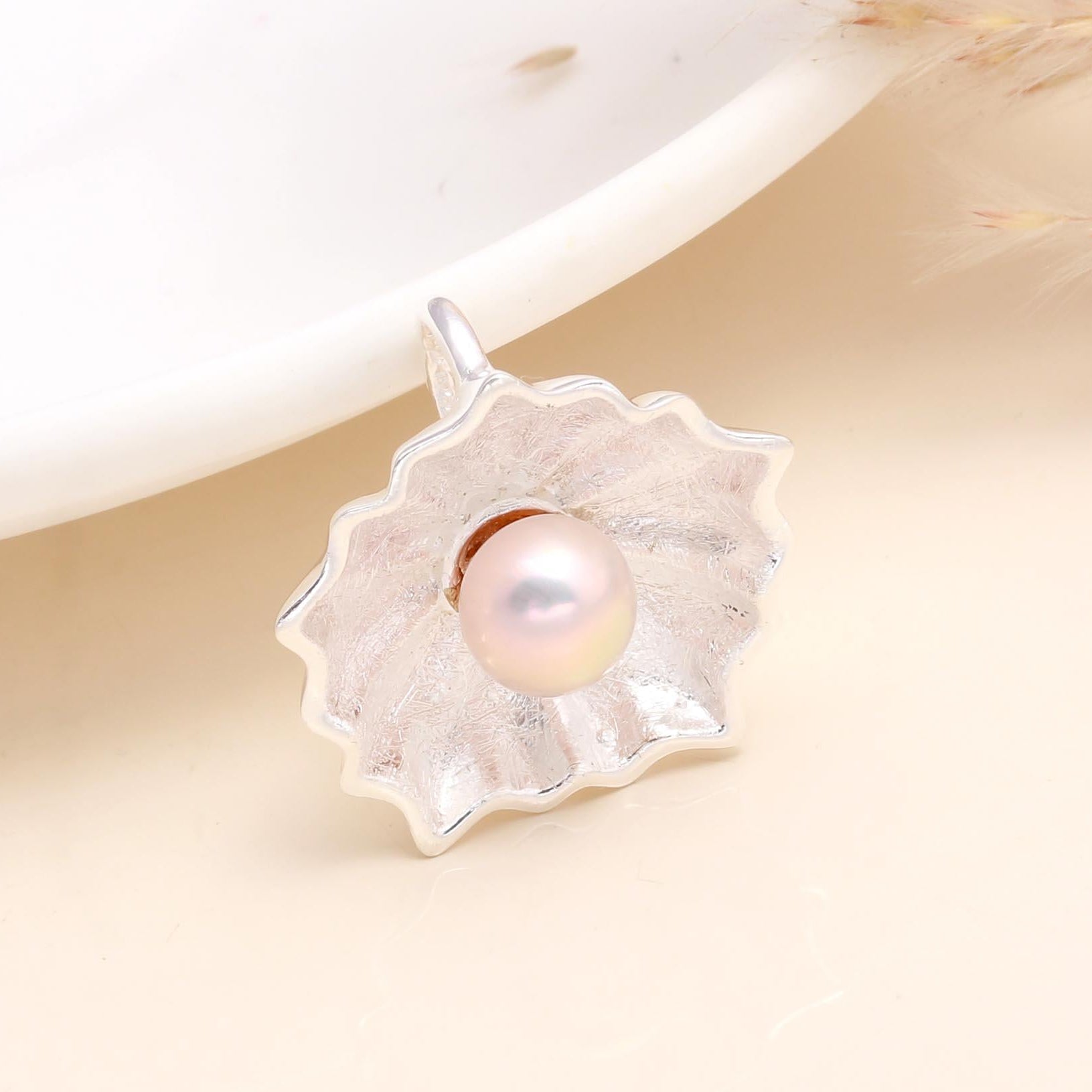 A 925 Sterling Silver Pink Pearl Flower Pendant displayed against a neutral background, with a natural pink freshwater pearl at the center of a floral design.