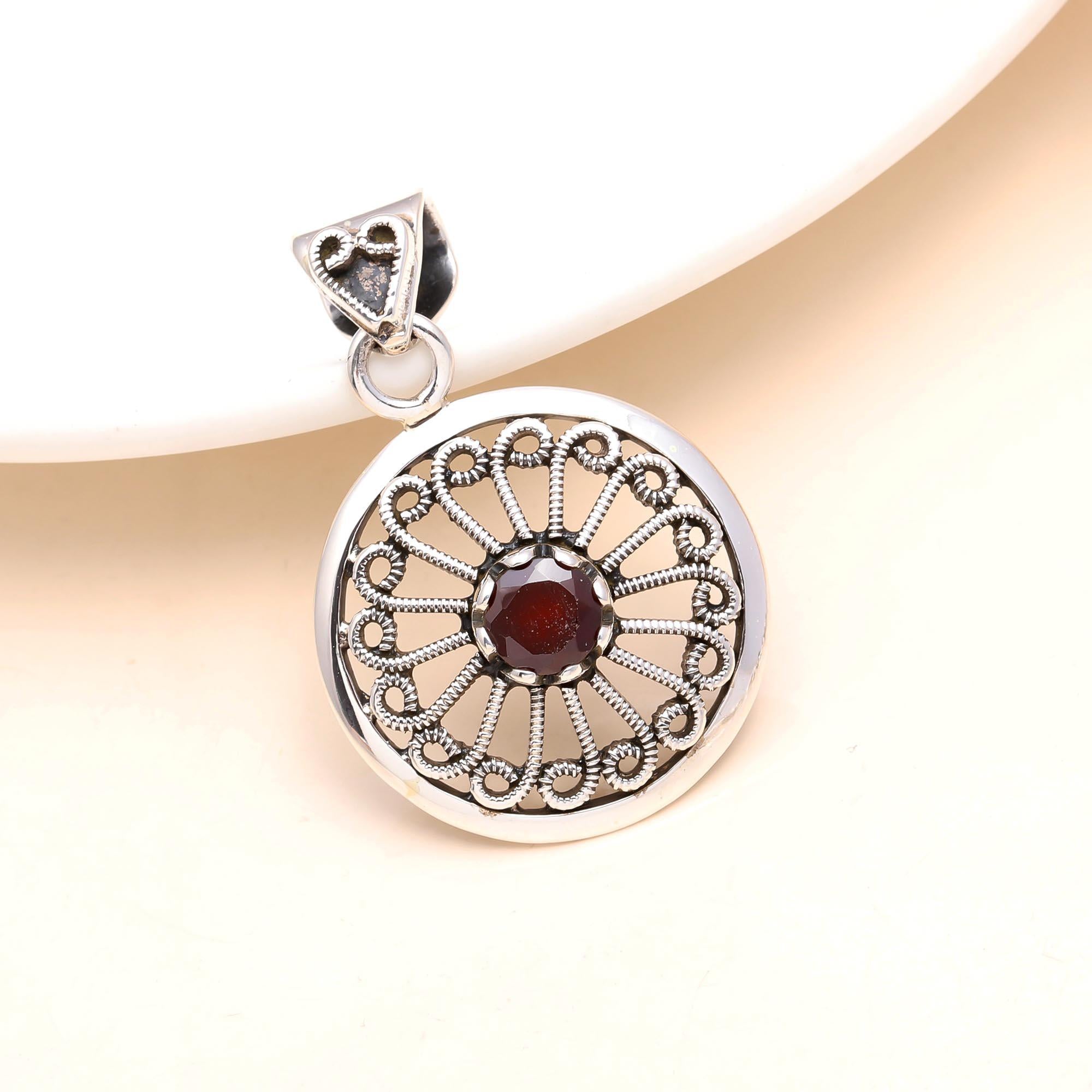The Garnet Sunwheel: Ornate Silver Circular Pendant