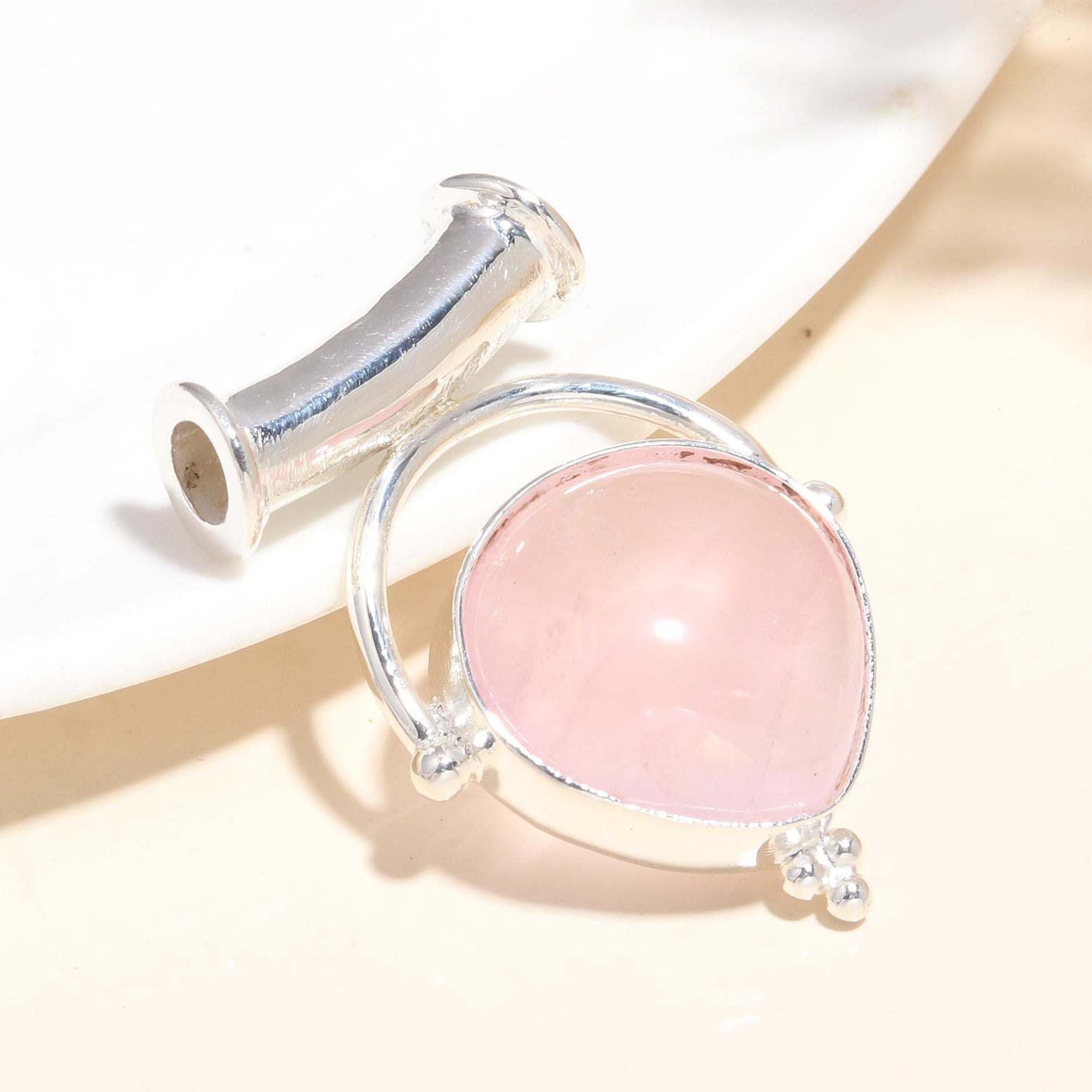 A 925 Sterling Silver pendant with a natural rose quartz gemstone, presented against a neutral background.