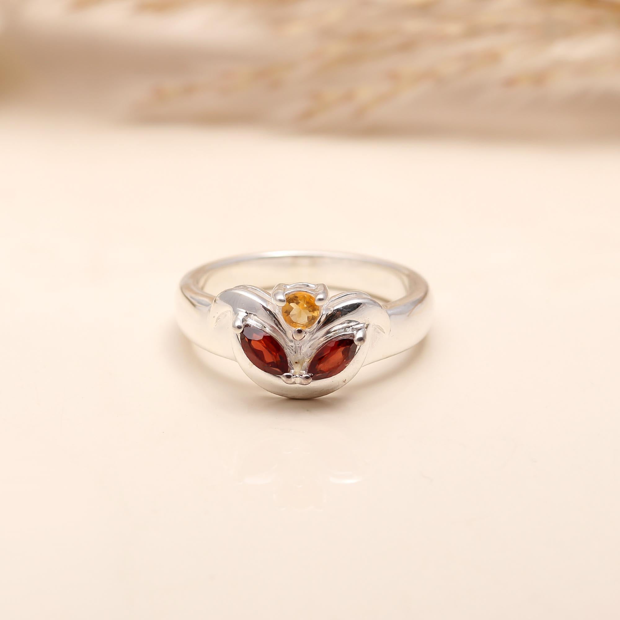Garnet gemstone shining against polished silver in the 925 Silver Garnet Ring.