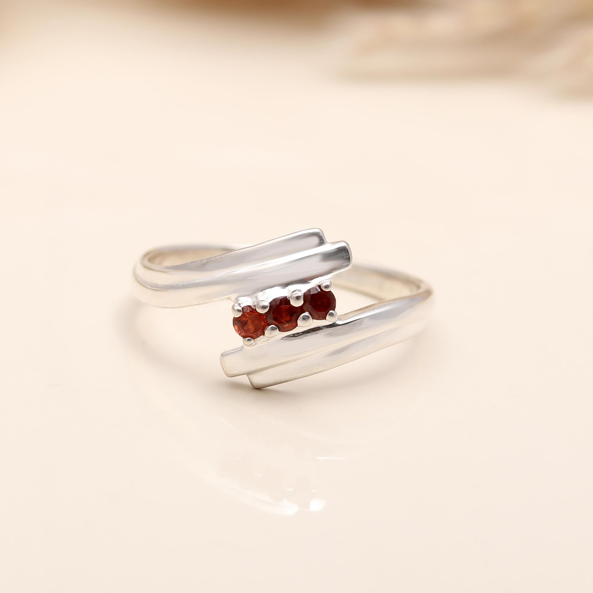 Elegant red garnet solitaire ring with bypass design