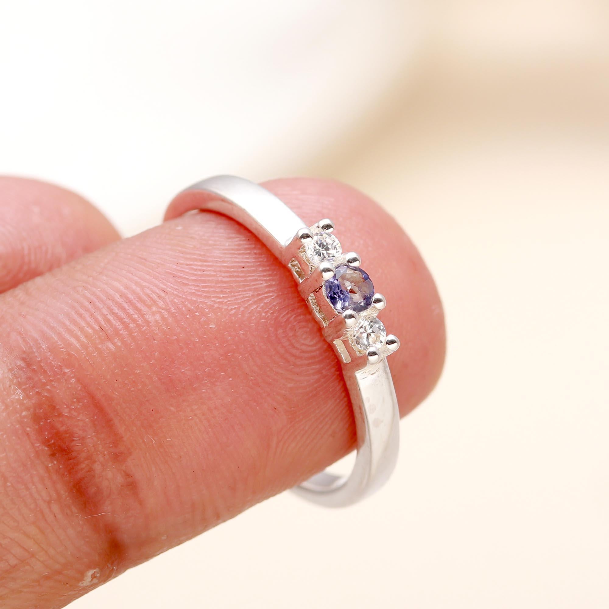 Elegant blue and white CZ ring on finger