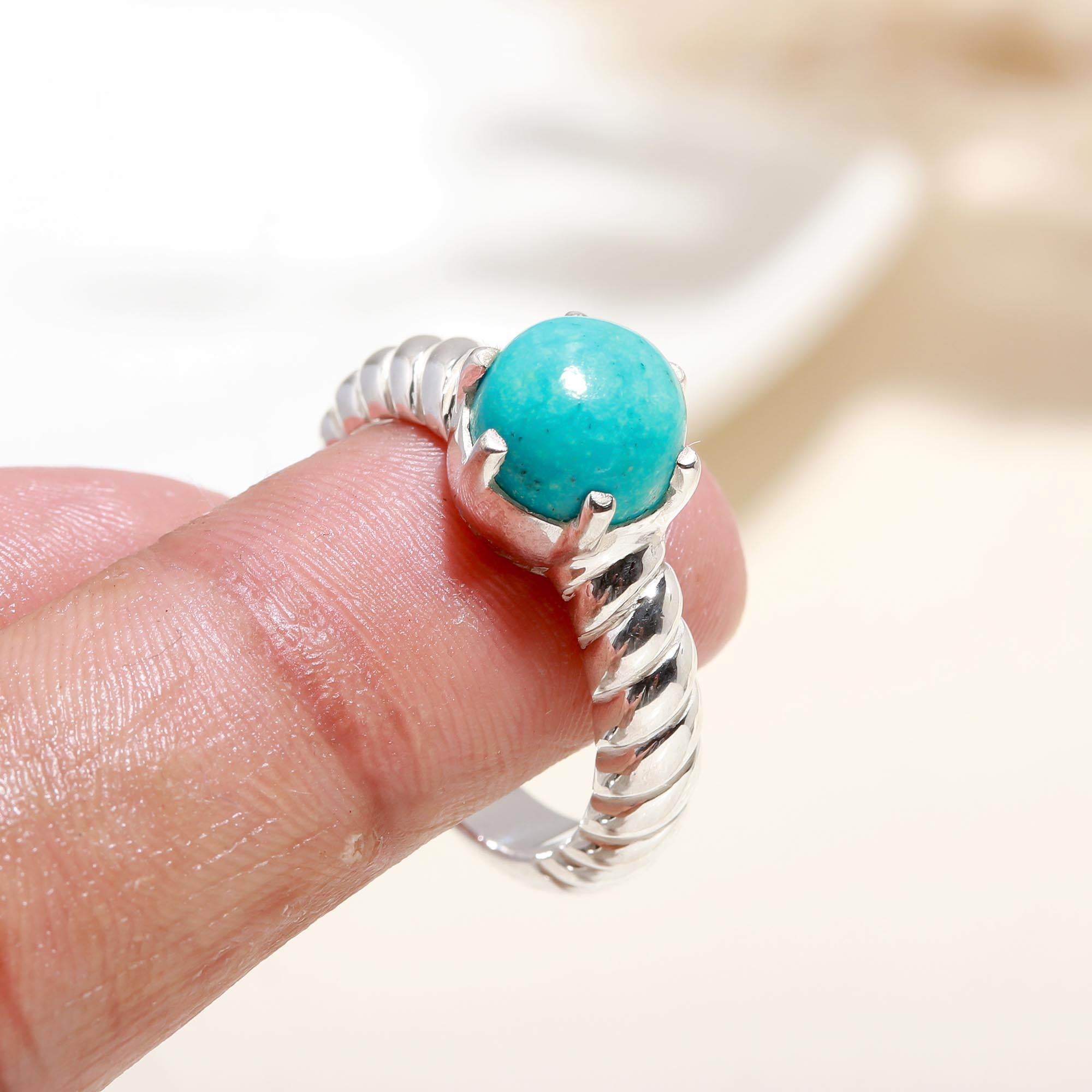 Elegant turquoise ring on finger
