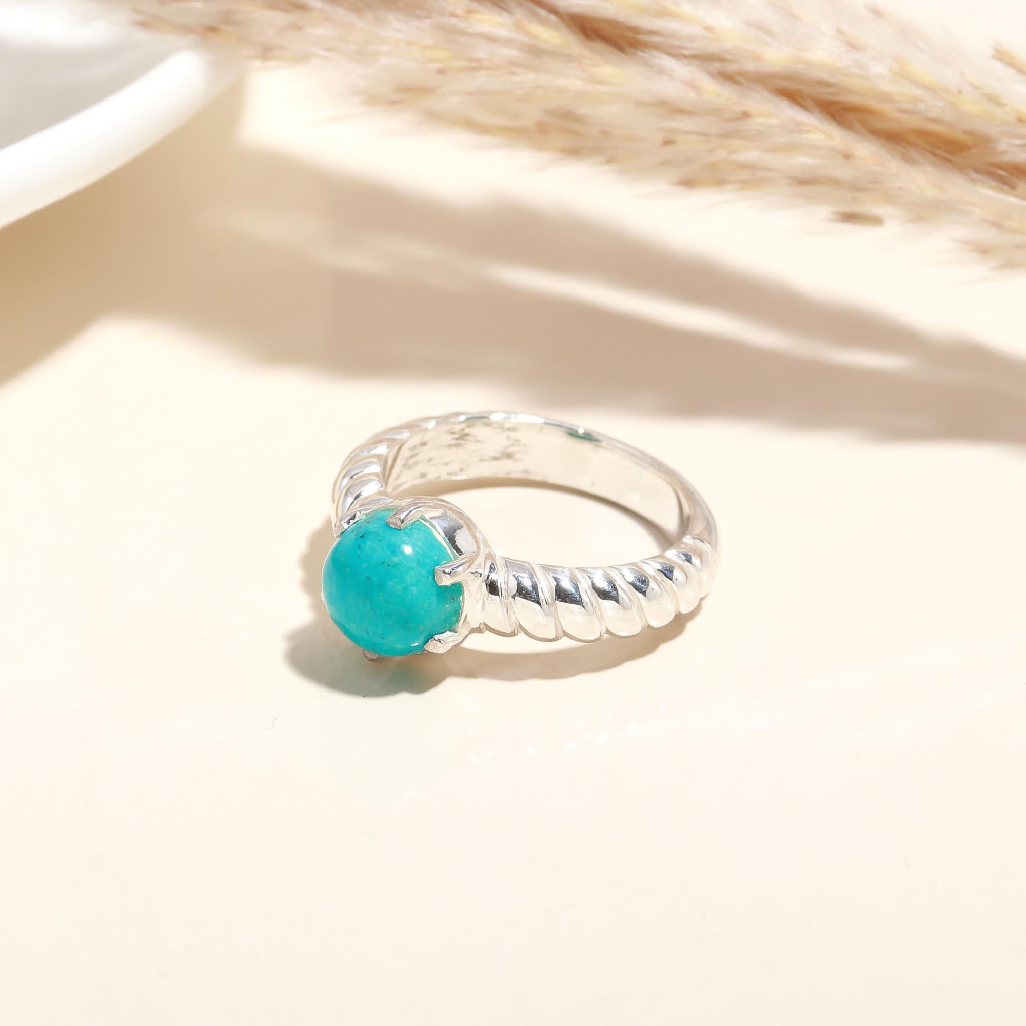 Close-up of turquoise cabochon twisted silver ring