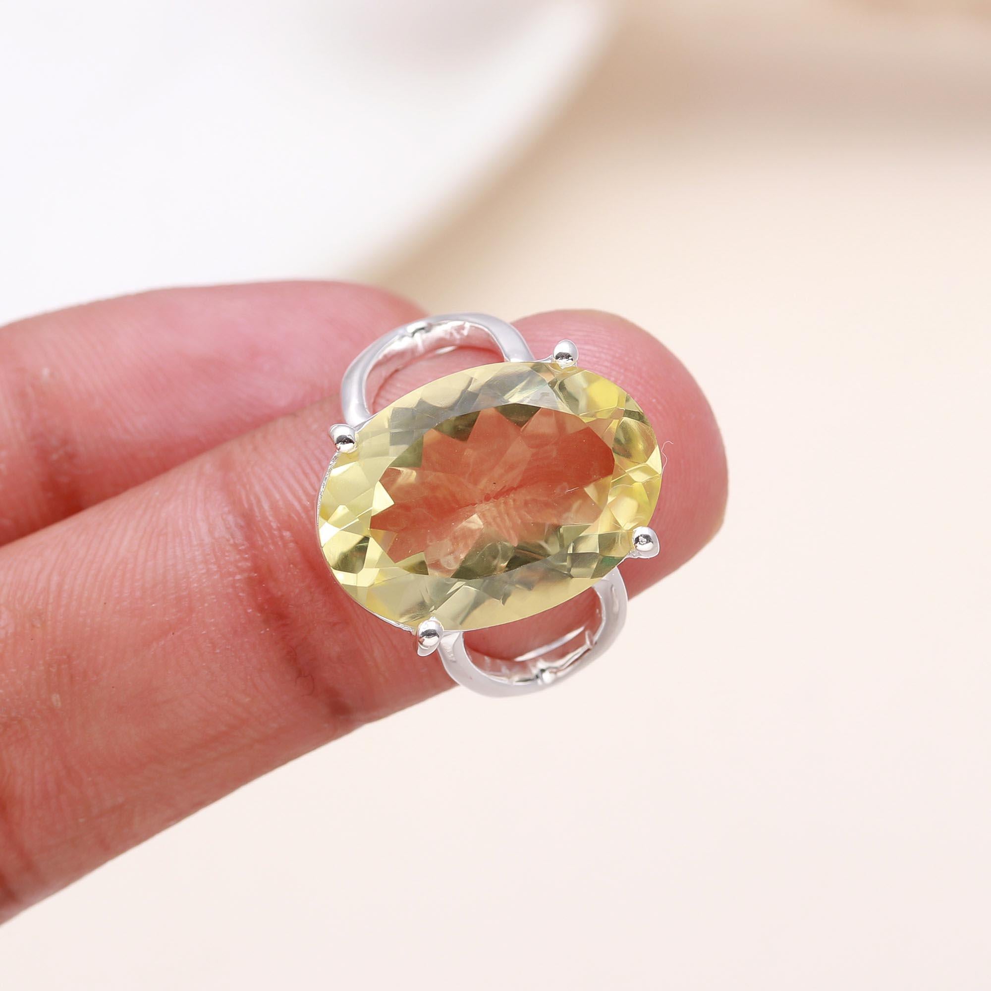 Elegant oval cut lemon quartz ring on finger
