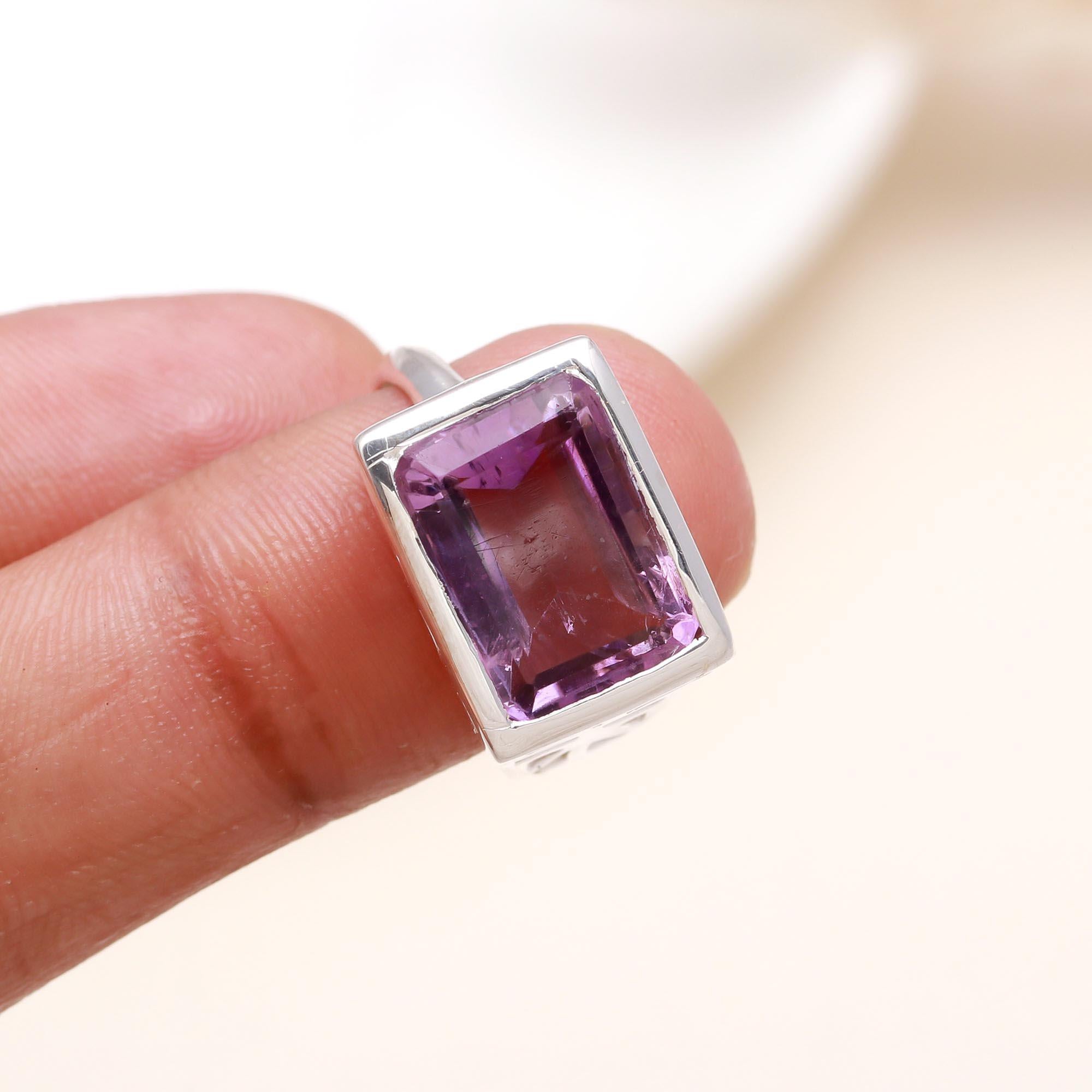 Elegant emerald cut amethyst gemstone ring on finger