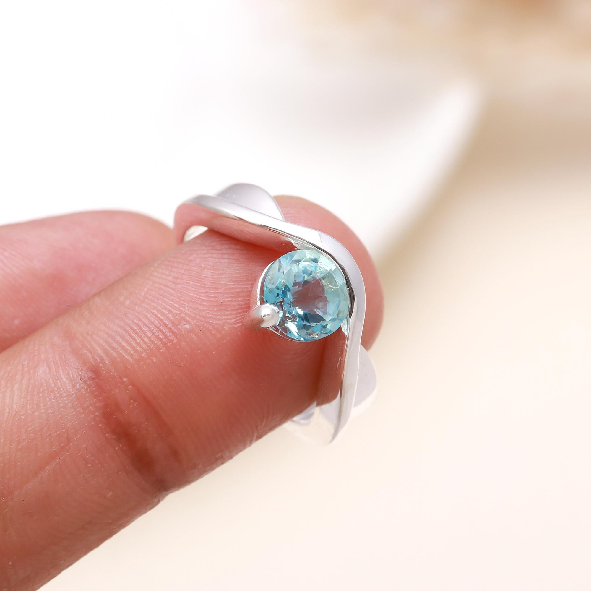 Elegant round aquamarine gemstone ring on finger