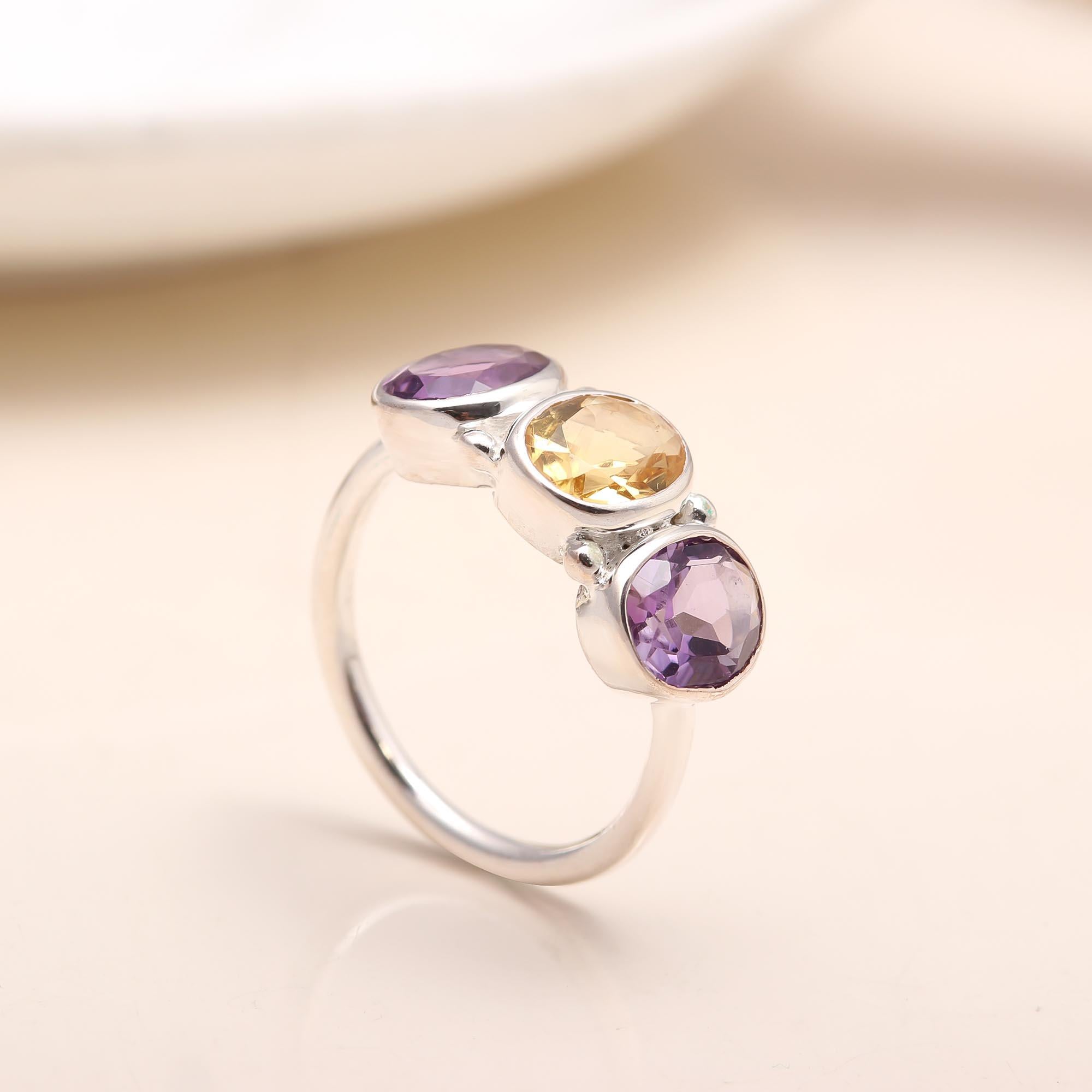 Close-up of amethyst and citrine gemstones on silver ring