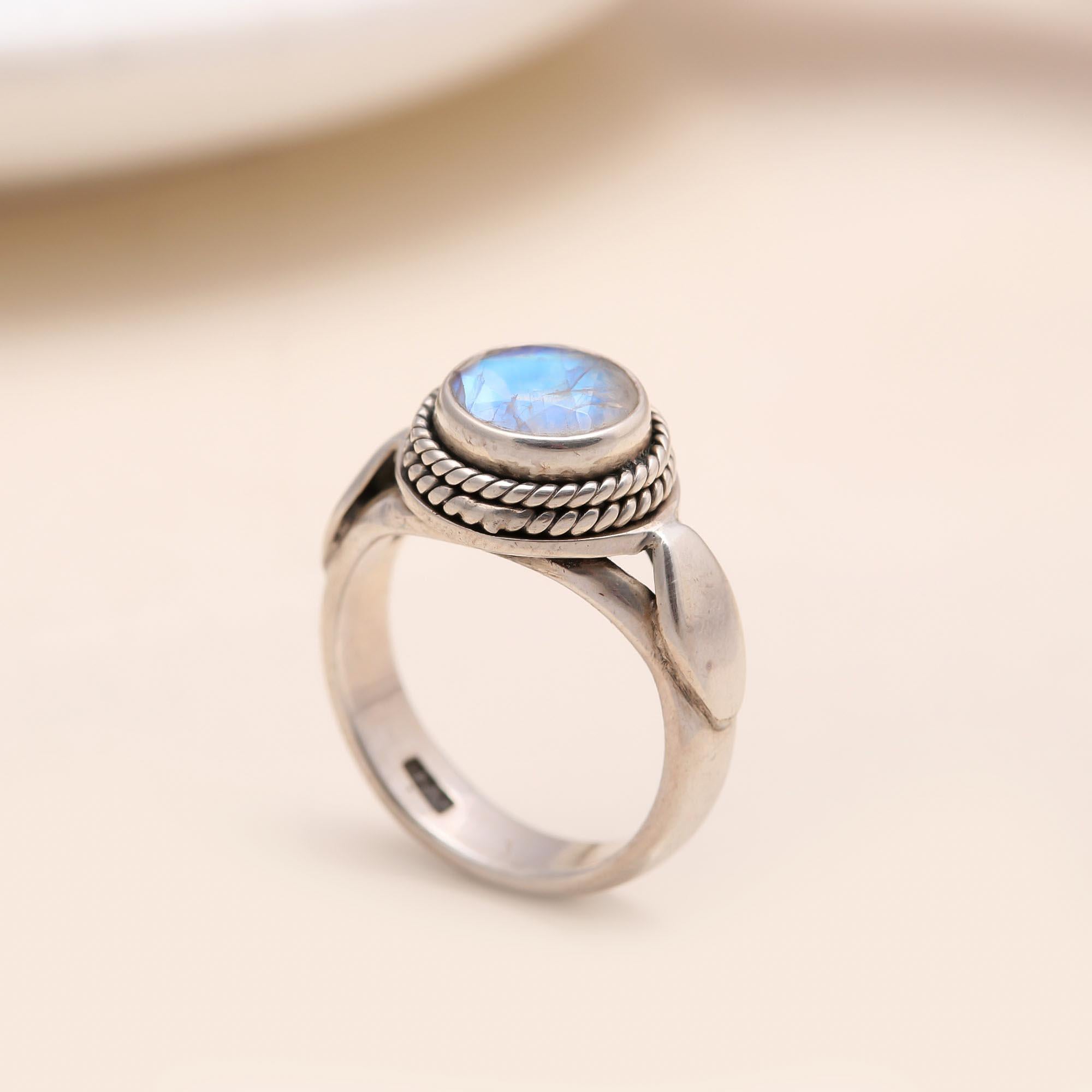 Close-up of round moonstone silver rope band ring